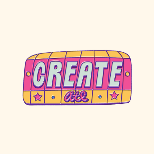 A 3" enamel pin with a yellow border that has ATL at the bottom, and white text on pink background that says CREATE above it in block letters.